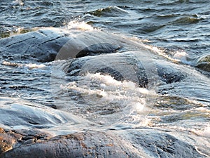 View of beautiful splash with foam on the rocks in Baltic sea, Sveaborg, Finland