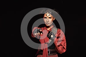 View of beautiful steampunk woman pointing with finger at camera isolated on black