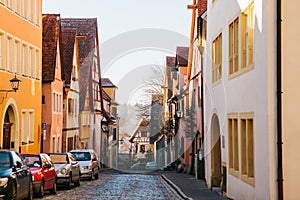 View of a beautiful street with traditional German houses in Rothenburg ob der Tauber in Germany. European city.