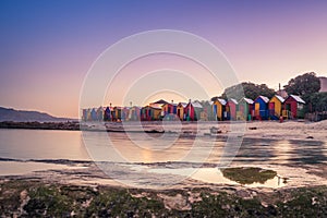 View of the beautiful sunset over False Bay from Kalkbay with little colorful houses, Cape Town