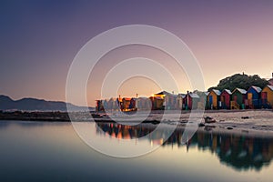 View of the beautiful sunset over False Bay from Kalkbay with little colorful houses, Cape Town