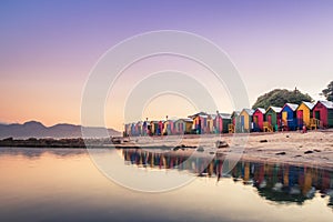View of the beautiful sunset over False Bay from Kalkbay with little colorful houses, Cape Town