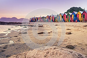 View of the beautiful sunset over False Bay from Kalkbay with little colorful houses, Cape Town