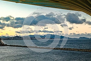 View of beautiful sunset with pepper clouds, sea and waves view from height. Skyline and coastline. Vertical photo.