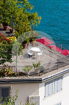 View of beautiful table with white chairs stands on the balkon. Decoration from flowers. Location for her morning photo session