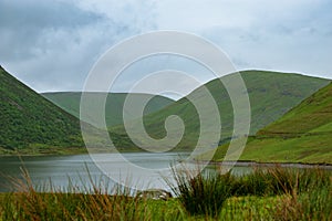 View of a beautlful lake Talla in Scottish borders with green hi photo