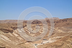 View of Bedouin camp in a wadi of the Judean Desert, with Dead Sea in background as seen from Masada Fortress
