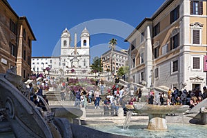 View from behind the Fontana della Barcaccia on Piazza di Spagna over the Spanish Steps towards The church Trinita dei Monti with