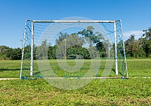 View from behind the soccer goal on an empty amateur soccer field in Brazil.