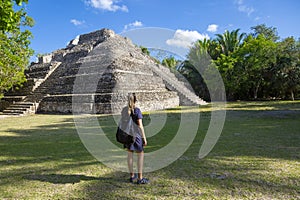 View from behind of a woman visiting Mayan Ruins in Central American.