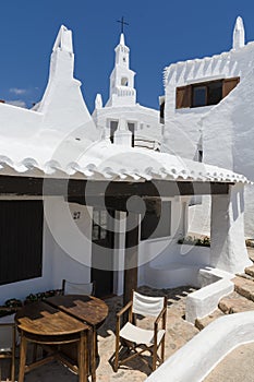 View with bell tower of the fishing village, Menorca, Spain