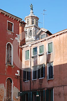 View of a bell tower and houses in Venice.