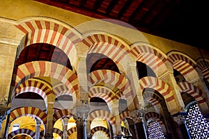 View from below of the arcaded hypostyle hall with 856 columns of  double arches in the Mosque - Cathedral of Cordoba, Spain photo