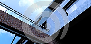 View from below on the facade of a traditional office building finished with decorative bricks and concrete. Panoramic reflective