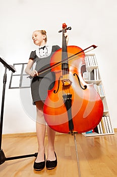 View from below of girl playing violoncello