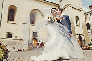 A view from below on the gorgeous wedding couple standing in the