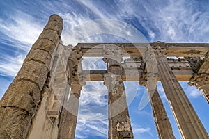 View from below of the marble columns with Greek capitals of the Roman temple of Diana with doves perched on the frontispiece.