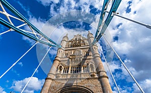 View from below in perspective and nadir plane of London\'s Tower Bridge illuminated by the sun. photo