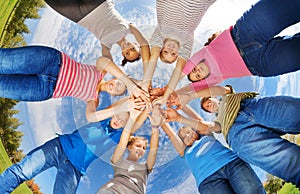 View from below of teens standing in star shape photo