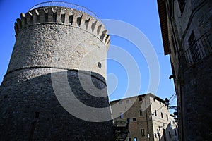 View from below of the tower of the castle of the village, against a light blue sky, Gualdo Cattaneo, Perugia, Umbria, Italy