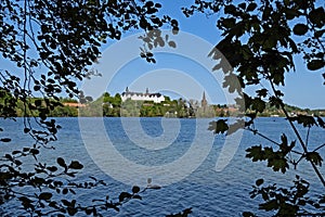 View of the big lake Ploen, the Ploen castle and the St. Nicholas church in Ploen, Schleswig-Holstein, Germany photo