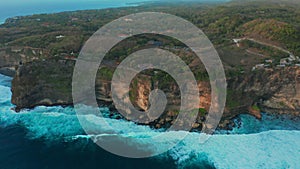 View on big ocean waves and rocks at the Uluwatu Temple, at the Bali island, Indonesia