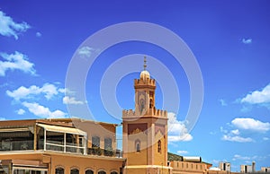 View of biggest tower on Jemaa EL Fnaa main city square. It is a beautiful sunny day at market place in Marrakesh& x27;s medina