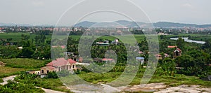 View of the Binh village with river, green grass, cloudy sky