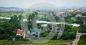 View of the Binh village with river, green grass, cloudy sky