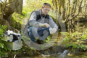 View of a Biologist take a sample in a river.