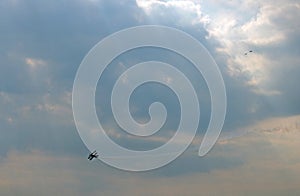 BIPLANE DOING AEROBATICS IN MORNING SKY photo