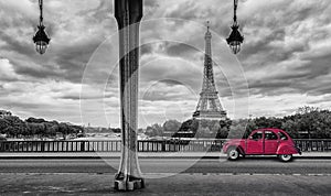 Eiffel Tower with vintage Car in Paris, seen from under the Bir Hakeim Bridge