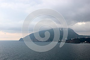 View of the Black sea and mountain Ayu-Dag Sleeping bear under stormy sky with clouds