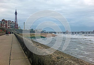 View of blackpool promenade in winter with stormy sea tower and central pier