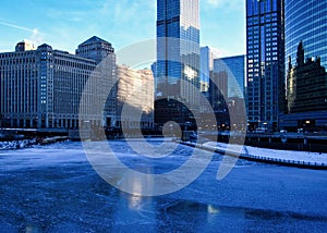 View of a blue and frigid winter morning in Chicago reflecting on a frozen Chicago River.