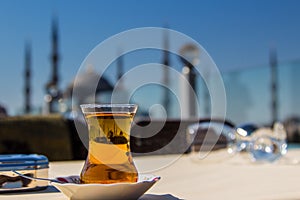 View of the Blue Mosque (Sultanahmet Camii) through a traditional turkish tea glass, Istanbul, Turkey