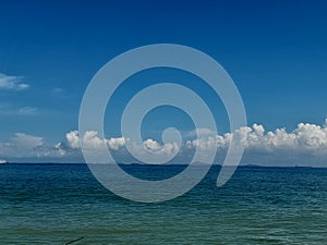 The view of the blue sea water looks so beautiful when the weather is sunny against the blue sky as a background.