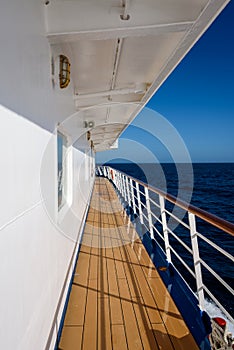 View of blue sky and blue ocean on sunny day from outside deck of cruise ship, Atlantic Ocean