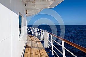 View of blue sky and blue ocean on sunny day from outside deck of cruise ship, Atlantic Ocean