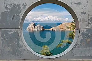 View of blue sky, sea and mountains through hole in concrete wall. Dream, vacation, travel concept