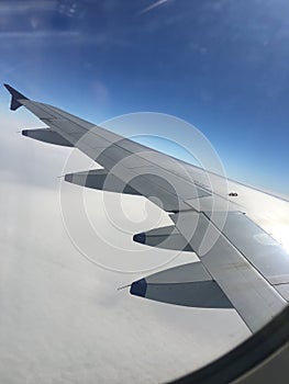 View Of blue sky from the window seat of a Airplane