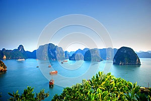 View of the blue waters and traditional junks in Halong Bay Vietnam