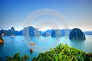 View of the blue waters and traditional junks in Halong Bay Vietnam photo