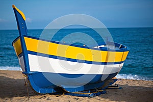 View of a boat in on a beach in Calella, Spain photo