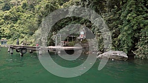 View from a boat departing from Trunyan cemetery entrance on shore, Bali