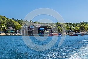 A view from a boat looking back towards the shoreline at West Bay on Roatan Island