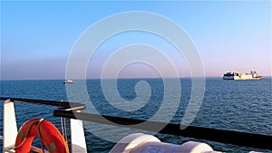 View of boat and pipelayer vessels from tugs deck on clear day