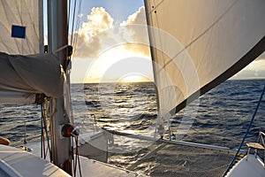 View of boat sails in sunset