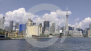 View from a boat on the sea of CN tower with the architectures of Toronto on a sunny day in Canada