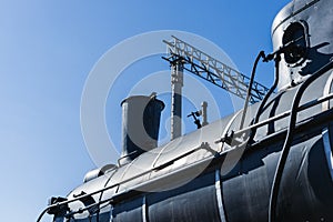 View of the boiler, chimney, and steam dome of an old steam loco